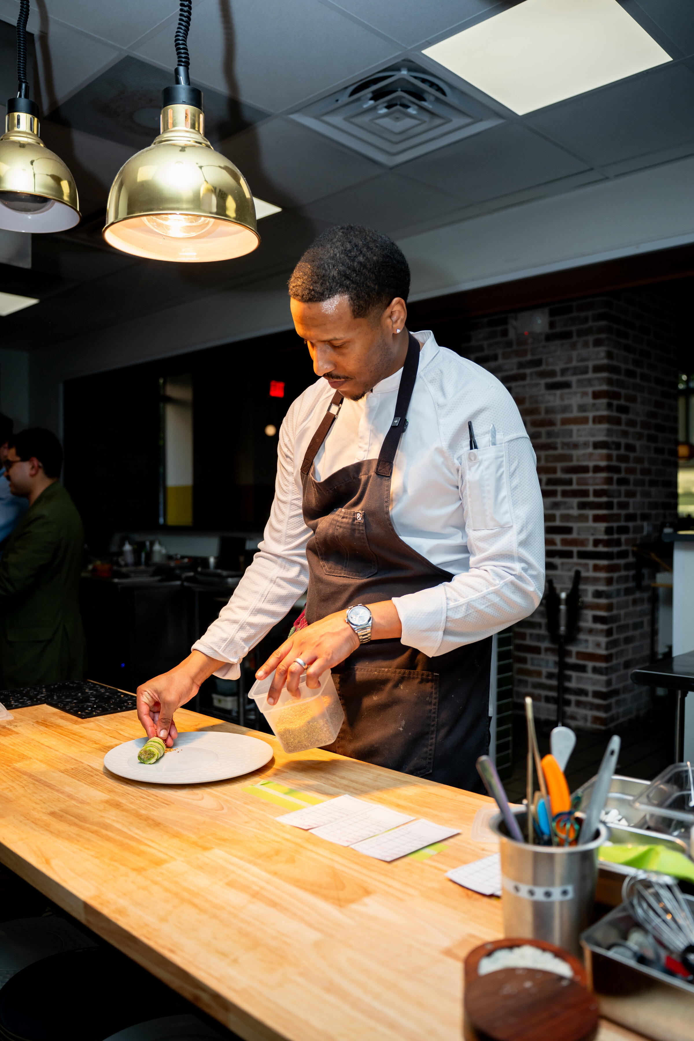 Chef Waymond Wesley II plating a Harrisburg course