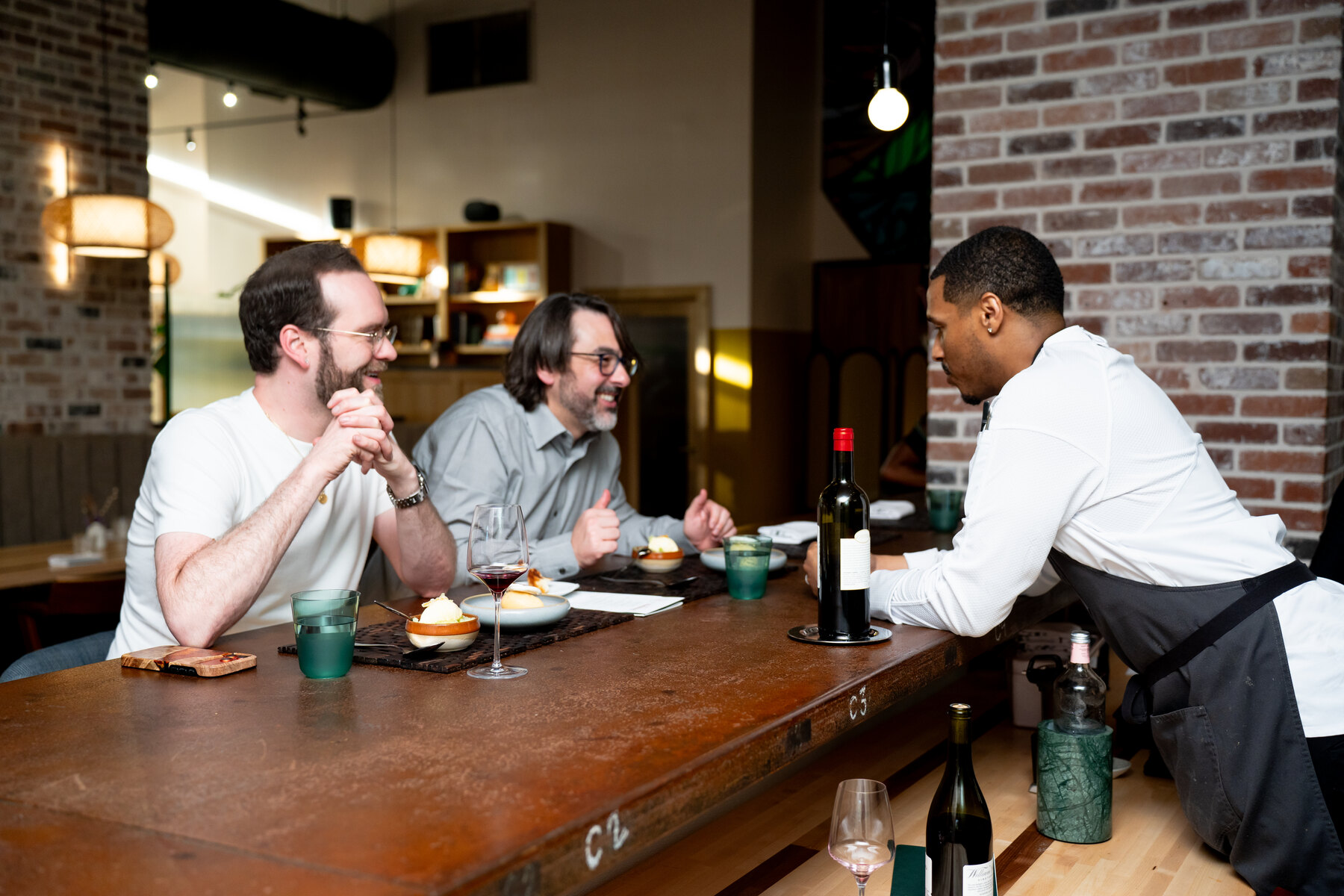 Chef Waymond Wesley II speaking with guests during service